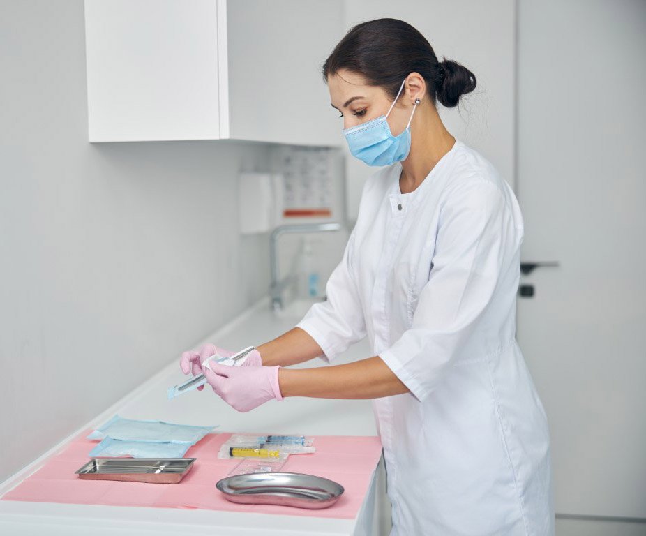 female cleaning surgical tools